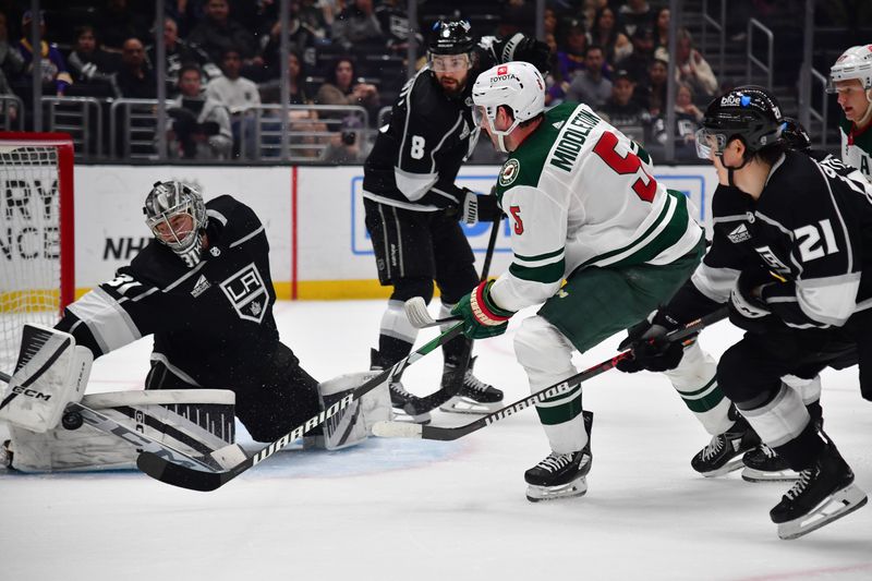 Mar 20, 2024; Los Angeles, California, USA; Los Angeles Kings goaltender David Rittich (31) blocks a shot against Minnesota Wild defenseman Jake Middleton (5) during the third period at Crypto.com Arena. Mandatory Credit: Gary A. Vasquez-USA TODAY Sports