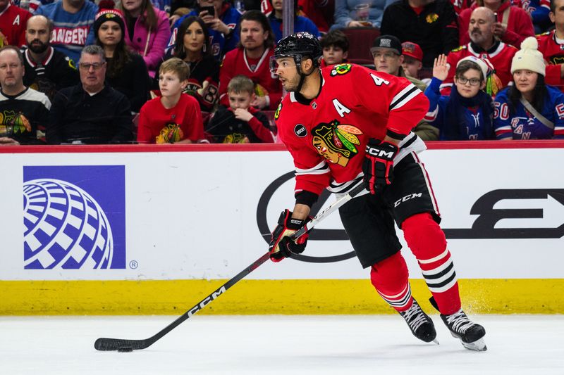 Feb 9, 2024; Chicago, Illinois, USA; Chicago Blackhawks defenseman Seth Jones (4) skates with the puck against the New York Rangers during the first period at the United Center. Mandatory Credit: Daniel Bartel-USA TODAY Sports