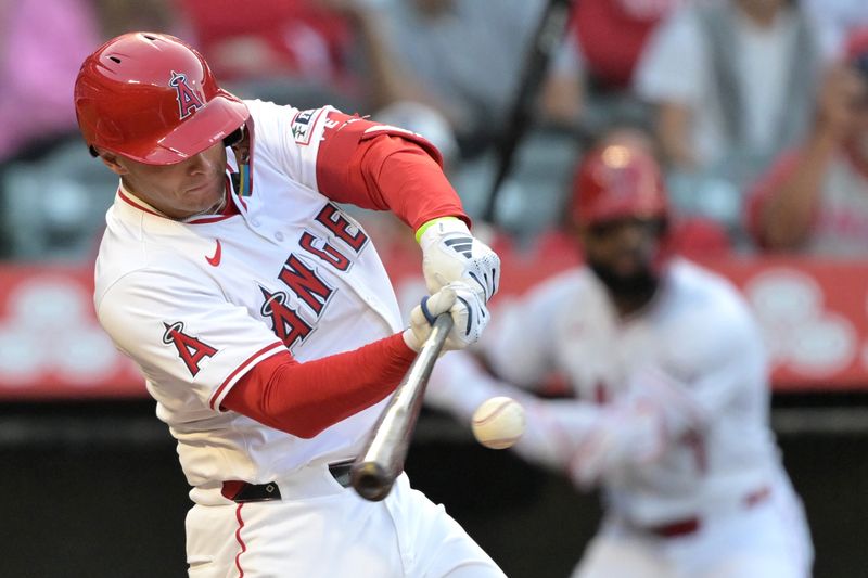 May 30, 2024; Anaheim, California, USA;  Los Angeles Angels catcher Logan O'Hoppe (14) hits a solo home run in the first inning against the New York Yankees at Angel Stadium. Mandatory Credit: Jayne Kamin-Oncea-USA TODAY Sports