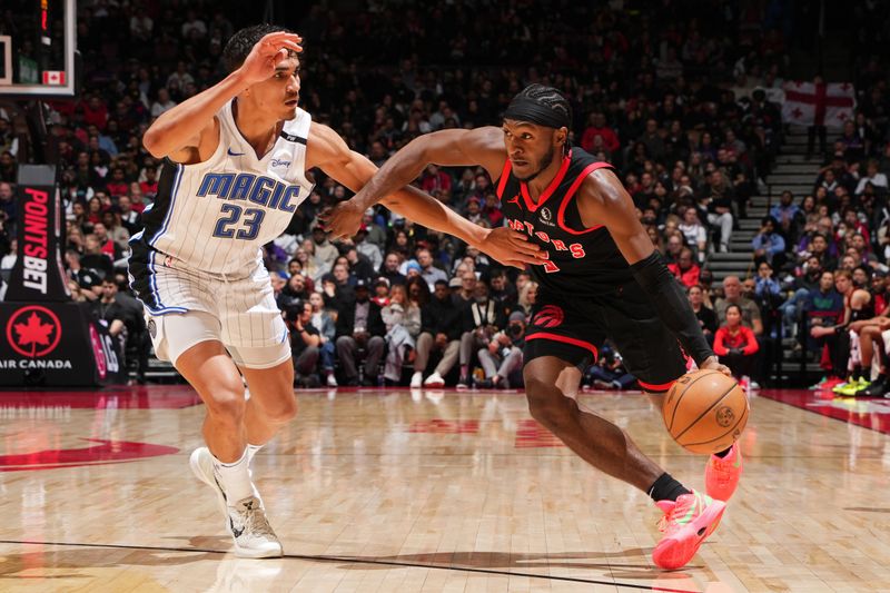 TORONTO, CANADA - JANUARY 3: Immanuel Quickley #5 of the Toronto Raptors handles the ball during the game against the Orlando Magic on January 3, 2025 at the Scotiabank Arena in Toronto, Ontario, Canada.  NOTE TO USER: User expressly acknowledges and agrees that, by downloading and or using this Photograph, user is consenting to the terms and conditions of the Getty Images License Agreement.  Mandatory Copyright Notice: Copyright 2025 NBAE(Photo by Mark Blinch/NBAE via Getty Images)