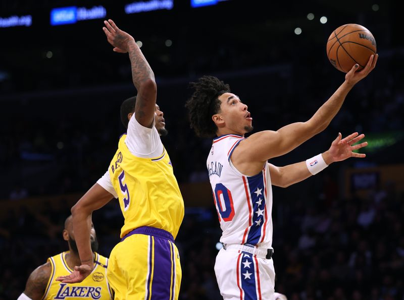 LOS ANGELES, CALIFORNIA - NOVEMBER 08: Jared McCain #20 of the Philadelphia 76ers scores on a layup past Cam Reddish #5 of the Los Angeles Lakers during the first half at Crypto.com Arena on November 08, 2024 in Los Angeles, California. (Photo by Harry How/Getty Images) NOTE TO USER: User expressly acknowledges and agrees that, by downloading and/or using this Photograph, user is consenting to the terms and conditions of the Getty Images License Agreement. (Photo by Harry How/Getty Images)