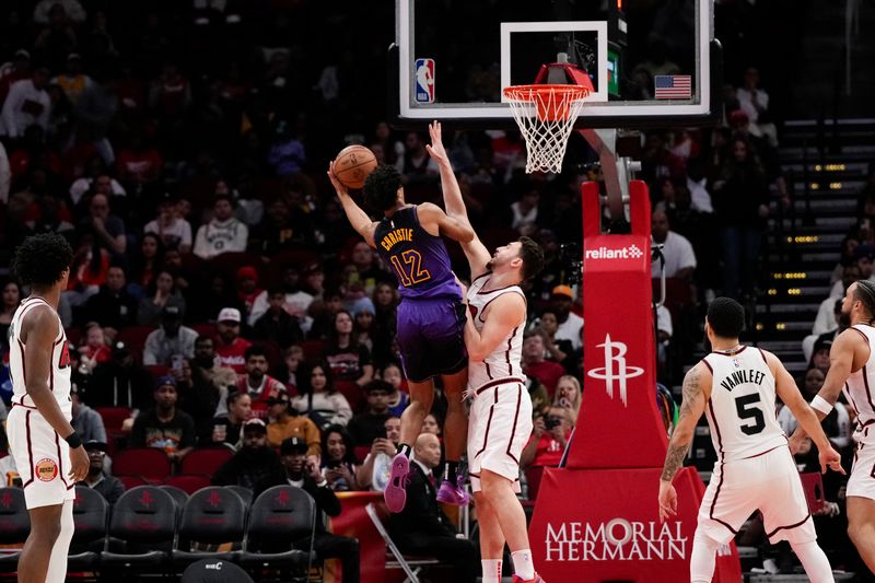 HOUSTON, TX - JANUARY 5:  Max Christie #12 of the Los Angeles Lakers drives to the basket during the game against the Houston Rockets on January 5, 2025 at the Toyota Center in Houston, Texas. NOTE TO USER: User expressly acknowledges and agrees that, by downloading and or using this photograph, User is consenting to the terms and conditions of the Getty Images License Agreement. Mandatory Copyright Notice: Copyright 2025 NBAE (Photo by Kevin M.Cox/NBAE via Getty Images)