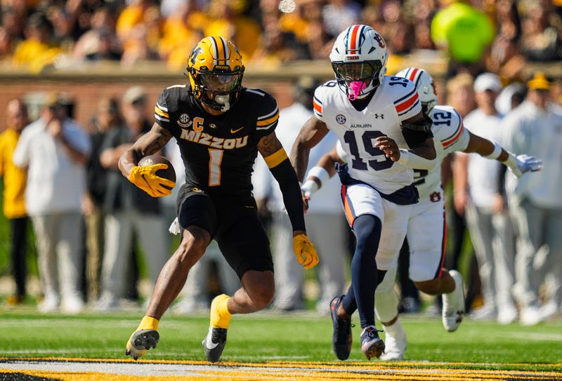 Oct 19, 2024; Columbia, Missouri, USA; Missouri Tigers wide receiver Theo Wease Jr. (1) runs with the ball against Auburn Tigers safety Sylvester Smith (19) during the first half at Faurot Field at Memorial Stadium. Mandatory Credit: Jay Biggerstaff-Imagn Images