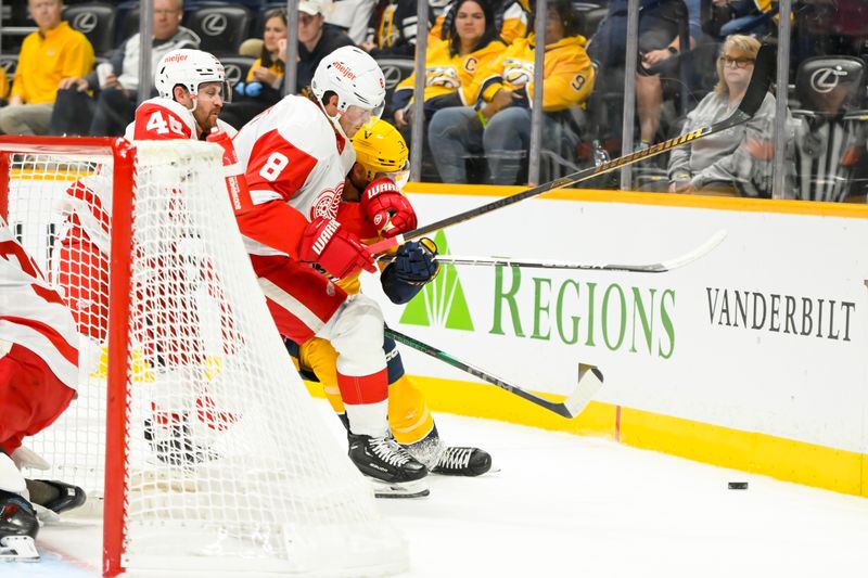 Oct 19, 2024; Nashville, Tennessee, USA; Detroit Red Wings defenseman Ben Chiarot (8) and Nashville Predators defenseman Jeremy Lauzon (3) battle for the puck during the first period at Bridgestone Arena. Mandatory Credit: Steve Roberts-Imagn Images