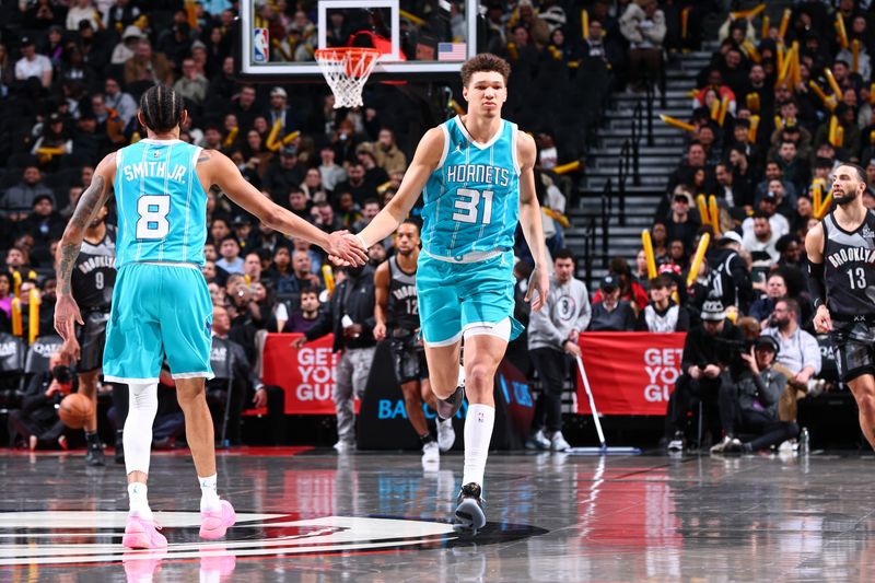 BROOKLYN, NY - FEBRUARY 10: Nick Smith Jr. #8 and Tidjane Salaun #31 of the Charlotte Hornets high five during the game against the Brooklyn Nets on February 10, 2025 at Barclays Center in Brooklyn, New York. NOTE TO USER: User expressly acknowledges and agrees that, by downloading and or using this Photograph, user is consenting to the terms and conditions of the Getty Images License Agreement. Mandatory Copyright Notice: Copyright 2025 NBAE (Photo by David L. Nemec/NBAE via Getty Images)