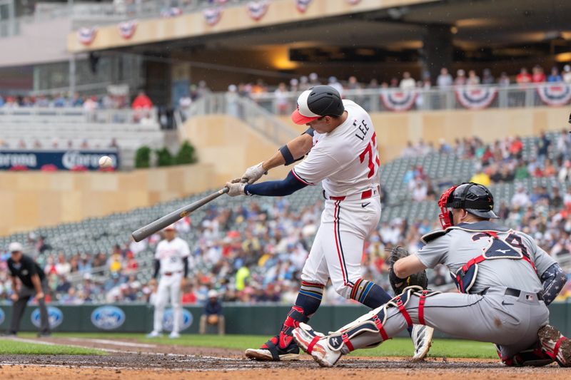 Jul 4, 2024; Minneapolis, Minnesota, USA; Minnesota Twins third baseman Brooks Lee (72) hits a sacrifice fly to right that scores Minnesota Twins catcher Ryan Jeffers (27) in the second inning against the Detroit Tigers at Target Field. Mandatory Credit: Matt Blewett-USA TODAY Sports