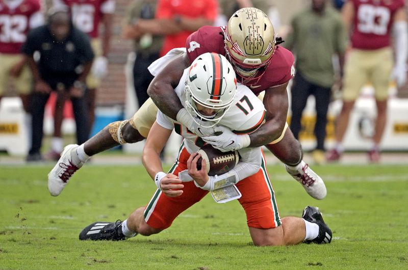 Nov 11, 2023; Tallahassee, Florida, USA; Florida State Seminoles linebacker Kalen Deloach (4) sacks Miami Hurricanes quarterback Emory Williams (17) during the first quarter at Doak S. Campbell Stadium. Mandatory Credit: Melina Myers-USA TODAY Sports