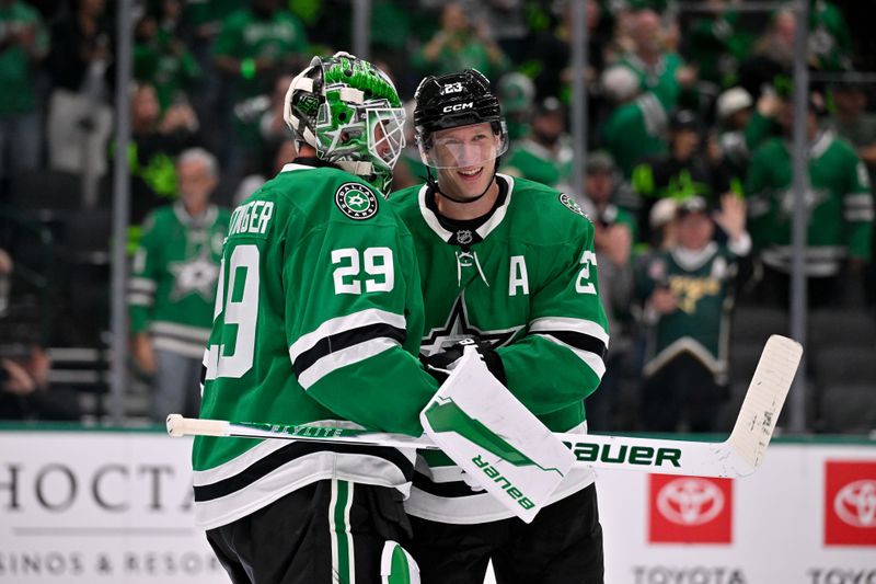 Oct 14, 2025; Dallas, Texas, USA; Dallas Stars goaltender Jake Oettinger (29) and defenseman Esa Lindell (23) celebrate the win over the Minnesota Wild at the American Airlines Center. Mandatory Credit: Jerome Miron-Imagn Images