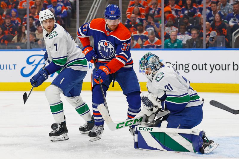 May 12, 2024; Edmonton, Alberta, CAN; Edmonton Oilers forward Warren Foegele (37) looks for a loose puck in front of Vancouver Canucks goaltender Arturs Silovs (31) during the first period in game three of the second round of the 2024 Stanley Cup Playoffs at Rogers Place. Mandatory Credit: Perry Nelson-USA TODAY Sports