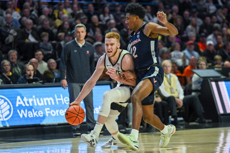 Jan 21, 2023; Winston-Salem, North Carolina, USA;  Wake Forest Demon Deacons guard Cameron Hildreth (2) dribbles up court against Virginia Cavaliers guard Reece Beekman (2) during the first half at Lawrence Joel Veterans Memorial Coliseum. Mandatory Credit: William Howard-USA TODAY Sports