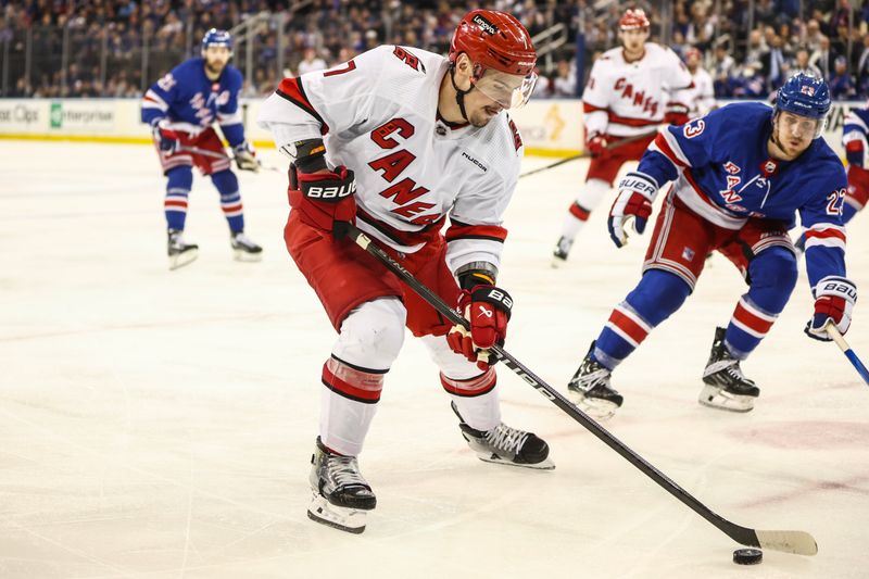 May 5, 2024; New York, New York, USA; Carolina Hurricanes defenseman Dmitry Orlov (7) controls the puck in the third period against the New York Rangers in game one of the second round of the 2024 Stanley Cup Playoffs at Madison Square Garden. Mandatory Credit: Wendell Cruz-USA TODAY Sports