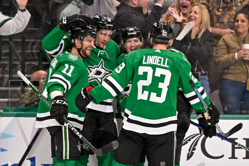 Oct 17, 2022; Dallas, Texas, USA; Dallas Stars center Luke Glendening (11) and center Radek Faksa (12) and left wing Joel Kiviranta (25) and defenseman Esa Lindell (23) celebrates a goal scored by Kiviranta against the Winnipeg Jets during the second period at the American Airlines Center. Mandatory Credit: Jerome Miron-USA TODAY Sports