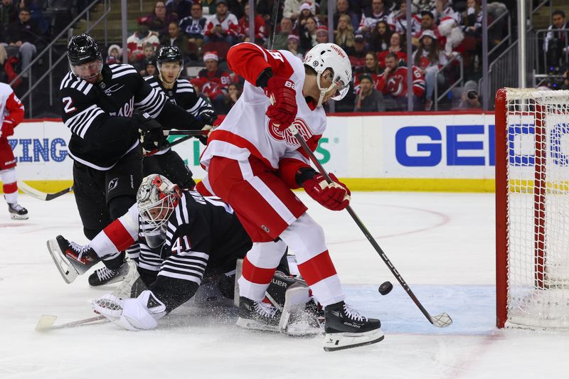 Dec 23, 2023; Newark, New Jersey, USA; Detroit Red Wings right wing Patrick Kane (88) tries to play the puck behind New Jersey Devils goaltender Vitek Vanecek (41) during the first period at Prudential Center. Mandatory Credit: Ed Mulholland-USA TODAY Sports