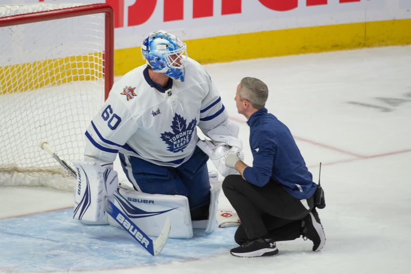 Dec 7, 2023; Ottawa, Ontario, CAN; Toronto Maple Leafs goalie Joseph Woll (60) is injured on a play in the third period against the  Ottawa Senators at the Canadian Tire Centre. Mandatory Credit: Marc DesRosiers-USA TODAY Sports