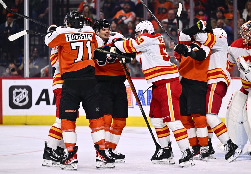 Jan 6, 2024; Philadelphia, Pennsylvania, USA; A scuffle breaks out between Philadelphia Flyers center Scott Laughton (21) and Calgary Flames defenseman MacKenzie Weegar (52) in the second period at Wells Fargo Center. Mandatory Credit: Kyle Ross-USA TODAY Sports