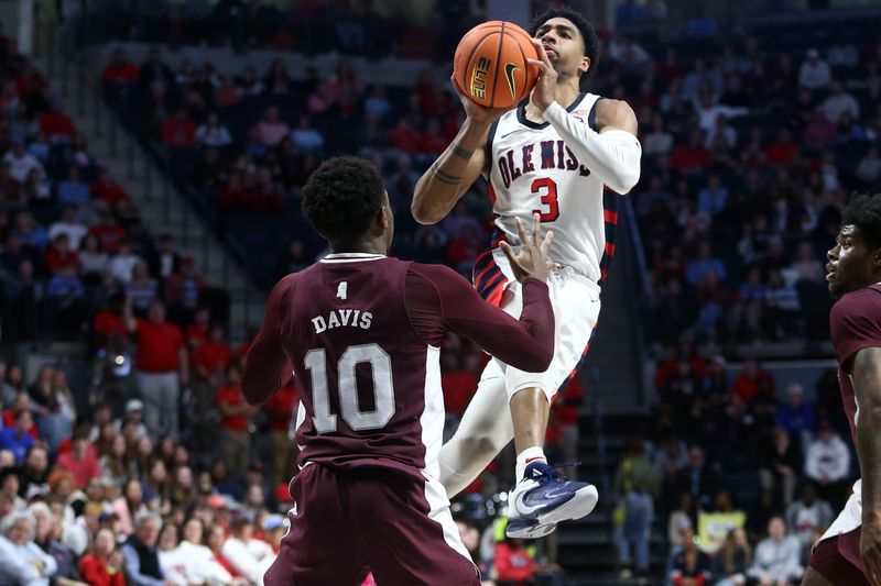 Feb 18, 2023; Oxford, Mississippi, USA; Mississippi Rebels forward Myles Burns (3) shoots as Mississippi State Bulldogs guard Dashawn Davis (10) defends during the second half at The Sandy and John Black Pavilion at Ole Miss. Mandatory Credit: Petre Thomas-USA TODAY Sports