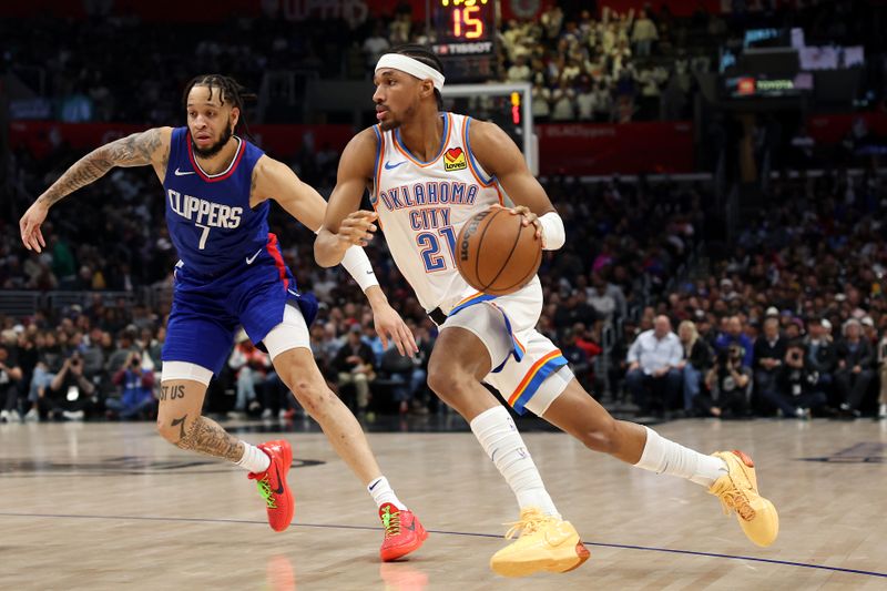 LOS ANGELES, CALIFORNIA - JANUARY 16: Aaron Wiggins #21 of the Oklahoma City Thunder drives to the basket against Amir Coffey #7 of the Los Angeles Clippers during the fourth quarter at Crypto.com Arena on January 16, 2024 in Los Angeles, California. NOTE TO USER: User expressly acknowledges and agrees that, by downloading and or using this photograph, User is consenting to the terms and conditions of the Getty Images License Agreement. (Photo by Katelyn Mulcahy/Getty Images)