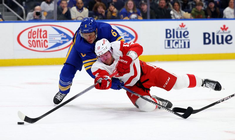 Dec 5, 2023; Buffalo, New York, USA;  Buffalo Sabres defenseman Erik Johnson (6) tries to defend as Detroit Red Wings right wing Daniel Sprong (17) takes a shot as he falls to the ice during the first period at KeyBank Center. Mandatory Credit: Timothy T. Ludwig-USA TODAY Sports