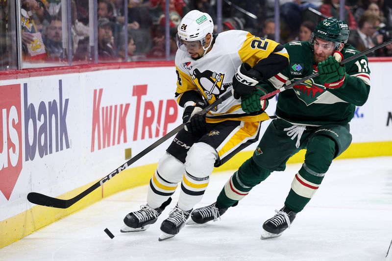 Oct 30, 2025; Saint Paul, Minnesota, USA; Pittsburgh Penguins defenseman Mathew Dumba (24) skates with the puck alongside Minnesota Wild center Yakov Trenin (13) during the second period at Grand Casino Arena. Mandatory Credit: Matt Krohn-Imagn Images