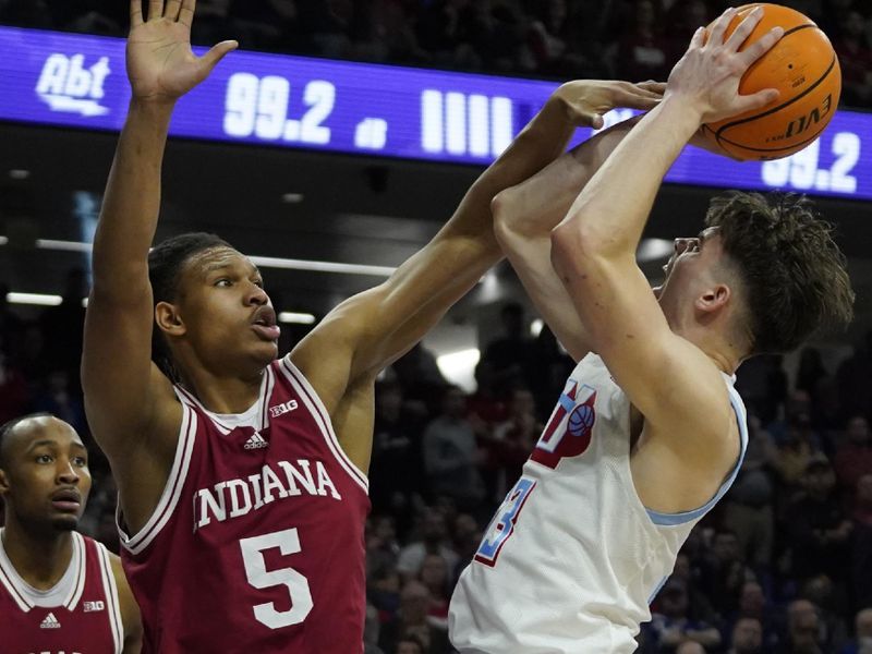 Feb 15, 2023; Evanston, Illinois, USA; Indiana Hoosiers forward Malik Reneau (5) defends Northwestern Wildcats guard Brooks Barnhizer (13) during the second half at Welsh-Ryan Arena. Mandatory Credit: David Banks-USA TODAY Sports