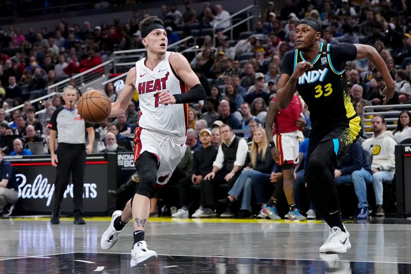 INDIANAPOLIS, INDIANA - APRIL 07: Tyler Herro #14 of the Miami Heat dribbles the ball while being guarded by Myles Turner #33 of the Indiana Pacers in the second quarter at Gainbridge Fieldhouse on April 07, 2024 in Indianapolis, Indiana. NOTE TO USER: User expressly acknowledges and agrees that, by downloading and or using this photograph, User is consenting to the terms and conditions of the Getty Images License Agreement. (Photo by Dylan Buell/Getty Images)