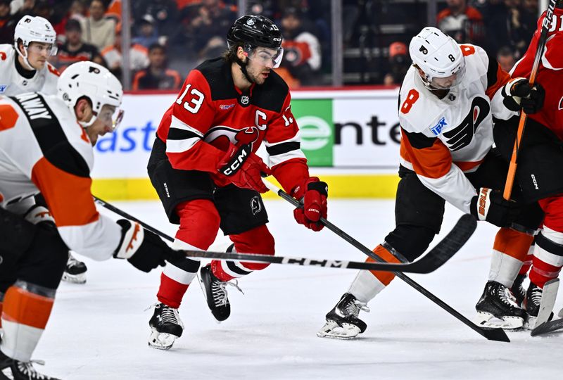 Apr 13, 2024; Philadelphia, Pennsylvania, USA; New Jersey Devils center Nico Hischier (13) chases the puck against the Philadelphia Flyers in the second period at Wells Fargo Center. Mandatory Credit: Kyle Ross-USA TODAY Sports