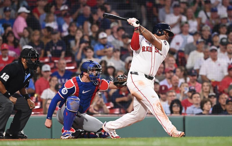 Aug 13, 2024; Boston, Massachusetts, USA; Boston Red Sox third baseman Rafael Devers (11) hits a single against the Texas Rangers during the fourth inning at Fenway Park. Mandatory Credit: Eric Canha-USA TODAY Sports