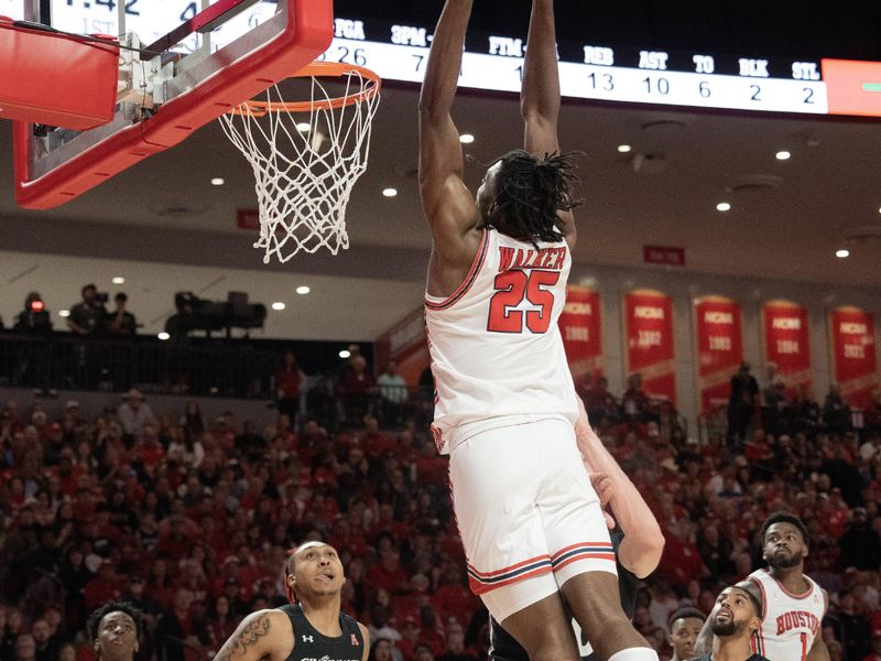 Jan 28, 2023; Houston, Texas, USA; Houston Cougars forward Jarace Walker (25) dunks against Cincinnati Bearcats guard Jeremiah Davenport (24) in the first half at Fertitta Center. Mandatory Credit: Thomas Shea-USA TODAY Sports