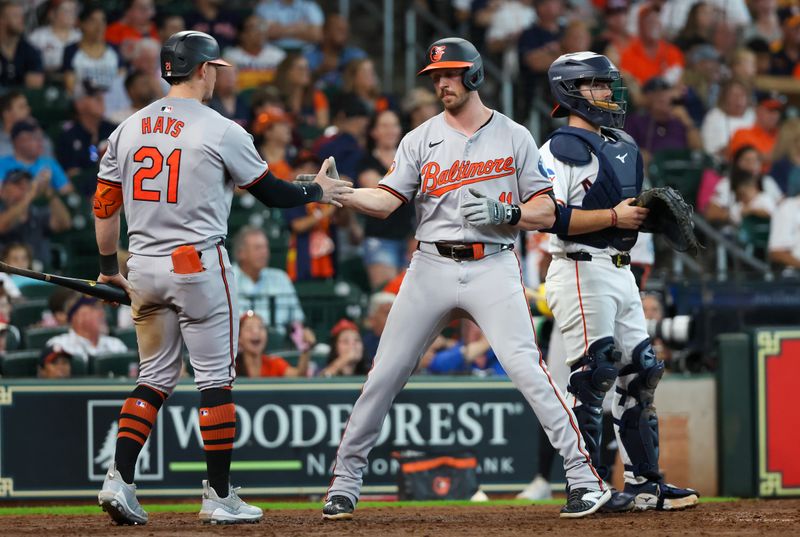 Jun 23, 2024; Houston, Texas, USA;  Baltimore Orioles left fielder Austin Hays (21) celebrates a home run by second baseman Jordan Westburg (11) against the Houston Astros in the sixth inning at Minute Maid Park. Mandatory Credit: Thomas Shea-USA TODAY Sports