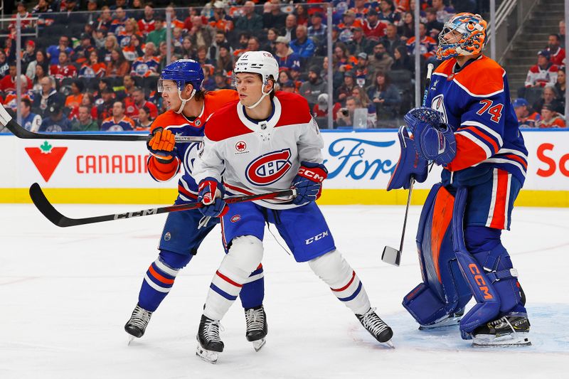 Mar 6, 2025; Edmonton, Alberta, CAN; Montreal Canadiens forward Jake Evans (71) battles with Edmonton Oilers defensemen Troy Stecher (51) in front of goaltender Stuart Skinner (74) during the second period at Rogers Place. Mandatory Credit: Perry Nelson-Imagn Images