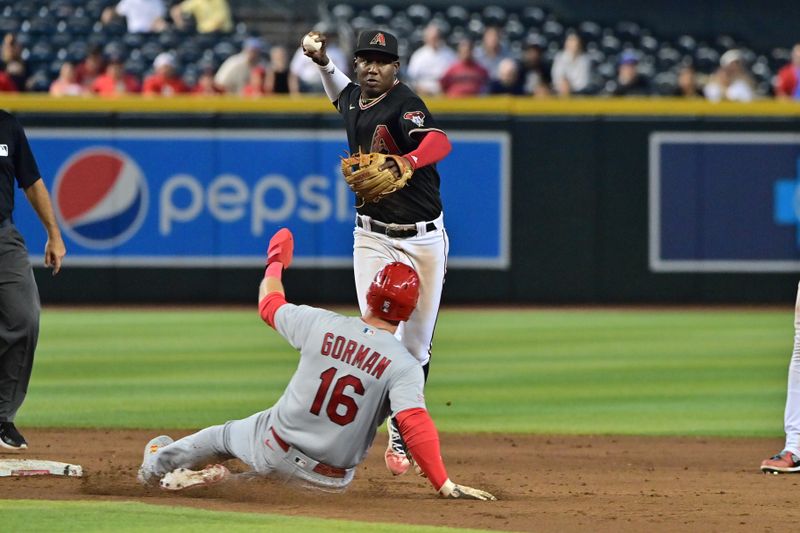 Jul 26, 2023; Phoenix, Arizona, USA;  Arizona Diamondbacks shortstop Geraldo Perdomo (2) turns a double play onSt. Louis Cardinals second baseman Nolan Gorman (16) in the ninth inning  at Chase Field. Mandatory Credit: Matt Kartozian-USA TODAY Sports