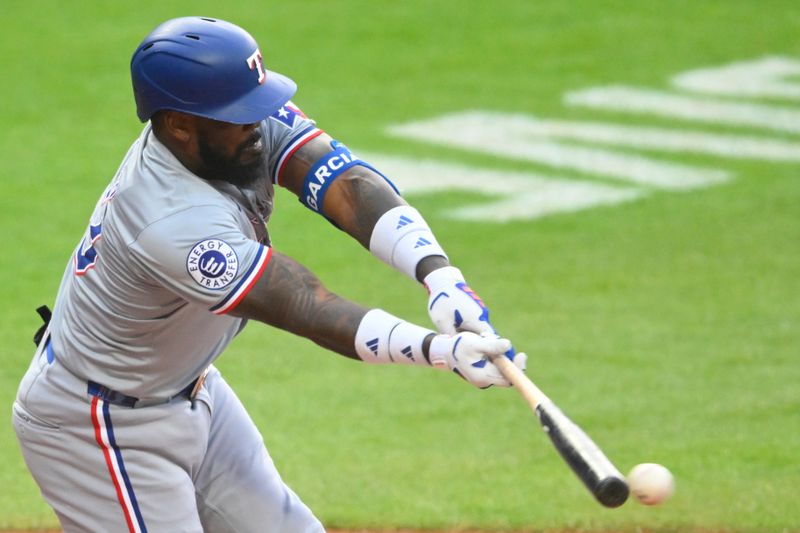 Aug 24, 2024; Cleveland, Ohio, USA; Texas Rangers right fielder Adolis García (53) singles in the first inning against the Cleveland Guardians at Progressive Field. Mandatory Credit: David Richard-USA TODAY Sports