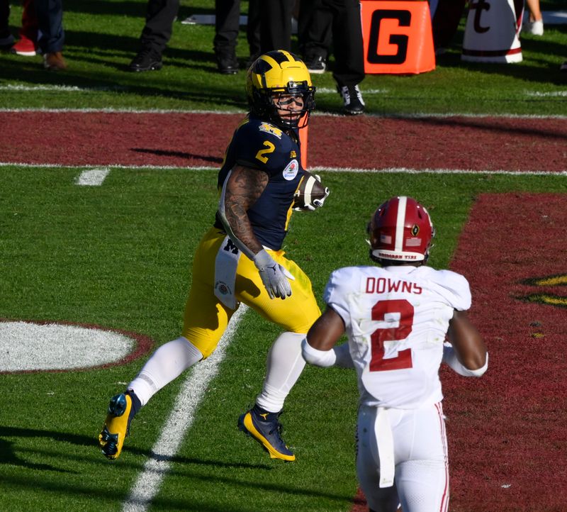 Jan 1, 2024; Pasadena, CA, USA; Michigan Wolverines running back Blake Corum (2) scores a touchdown past Alabama Crimson Tide defensive back Caleb Downs (2) in the 2nd quarter of the 2024 Rose Bowl college football playoff semifinal game at Rose Bowl. Mandatory Credit: Robert Hanashiro-USA TODAY Sports