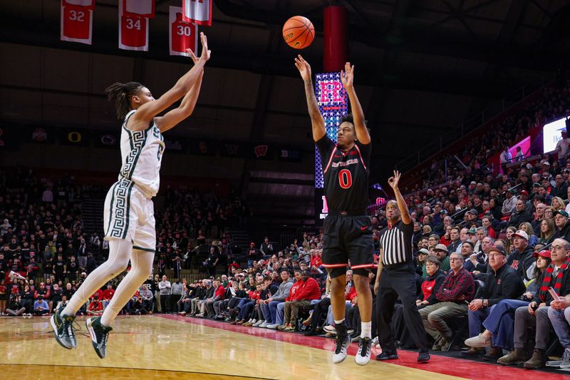 Jan 27, 2026; Piscataway, New Jersey, USA; Rutgers Scarlet Knights guard Tariq Francis (0) makes a three point basket as Michigan State Spartans forward Jordan Scott (6) defends during the second half at Jersey Mike's Arena. Mandatory Credit: Vincent Carchietta-Imagn Images