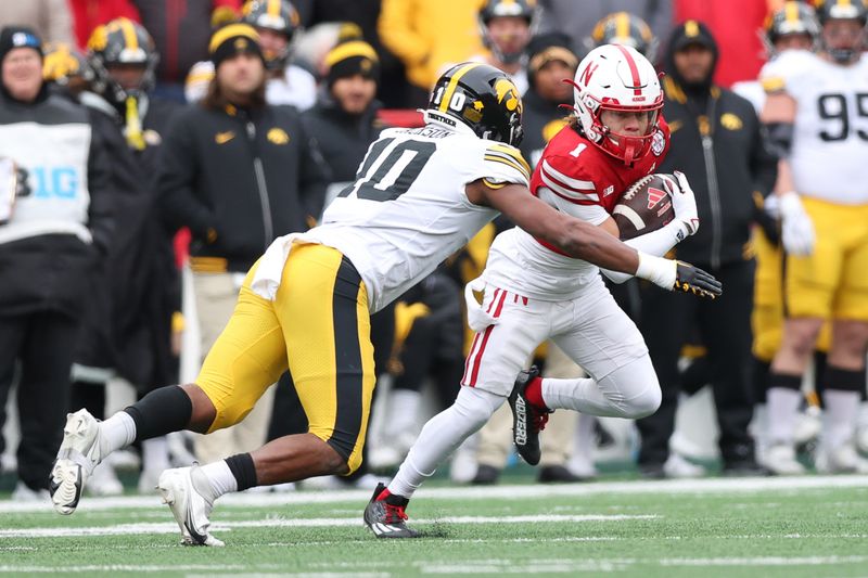 Nov 24, 2023; Lincoln, Nebraska, USA;  Iowa Hawkeyes linebacker Nick Jackson (10) tackles Nebraska Cornhuskers wide receiver Billy Kemp IV at Memorial Stadium. Mandatory Credit: Reese Strickland-USA TODAY Sports