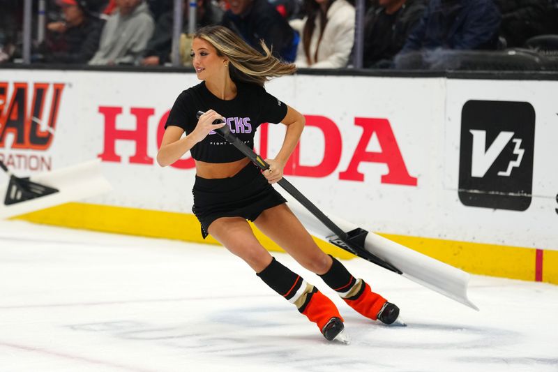 Nov 20, 2025; Anaheim, California, USA; An Anaheim Ducks power player ice crew member clears the ice in the second period at Honda Center. Mandatory Credit: Kirby Lee-Imagn Images