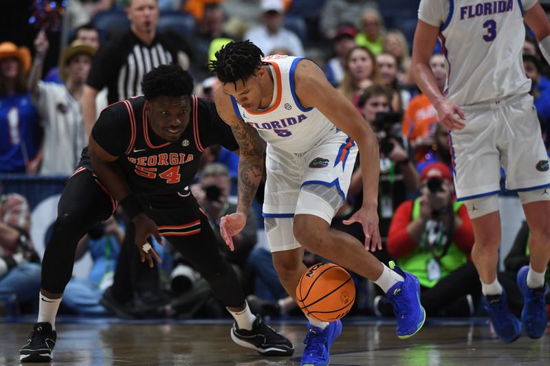 Mar 14, 2024; Nashville, TN, USA; Florida Gators guard Will Richard (5) and Georgia Bulldogs center Russel Tchewa (54) work for a loose ball during the first half at Bridgestone Arena. Mandatory Credit: Christopher Hanewinckel-USA TODAY Sports