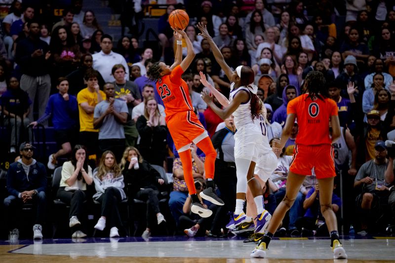 Feb 22, 2024; Baton Rouge, Louisiana, USA;  Auburn Tigers guard Honesty Scott-Grayson (23) shoots a jumper against LSU Lady Tigers guard Flau'jae Johnson (4) during the second half at Pete Maravich Assembly Center. Mandatory Credit: Matthew Hinton-USA TODAY Sports