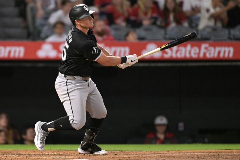 Sep 16, 2024; Anaheim, California, USA;  Chicago White Sox first baseman Andrew Vaughn (25) hits a triple in the second inning against the Los Angeles Angels at Angel Stadium. Mandatory Credit: Jayne Kamin-Oncea-Imagn Images