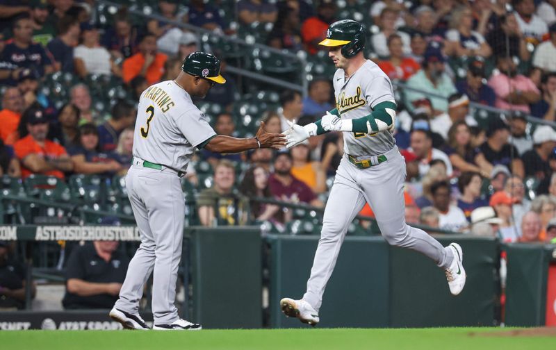 Sep 11, 2023; Houston, Texas, USA; Oakland Athletics right fielder Brent Rooker (25) celebrates with third base coach Eric Martins (3) after hitting a home run during the second inning against the Houston Astros at Minute Maid Park. Mandatory Credit: Troy Taormina-USA TODAY Sports