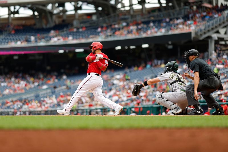 Aug 13, 2023; Washington, District of Columbia, USA; Washington Nationals designated hitter Keibert Ruiz (20) hits a single against the Oakland Athletics during the first inning at Nationals Park. Mandatory Credit: Geoff Burke-USA TODAY Sports