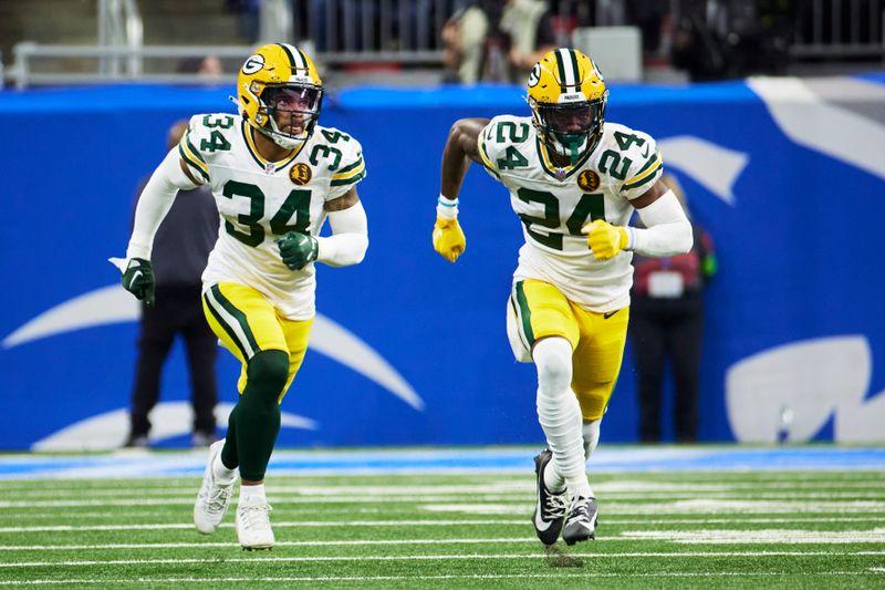 Green Bay Packers safety Jonathan Owens (34) and cornerback Kyu Blu Kelly (24) pursue a play against the Detroit Lions during an NFL football game at Ford Field in Detroit, Thursday, Nov. 23, 2023. (AP Photo/Rick Osentoski)