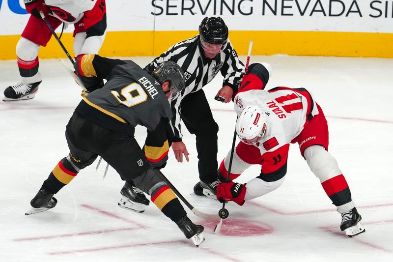Oct 20, 2025; Las Vegas, Nevada, USA; Vegas Golden Knights center Jack Eichel (9) takes a face off against Carolina Hurricanes center Jordan Staal (11) during the third period at T-Mobile Arena. Mandatory Credit: Stephen R. Sylvanie-Imagn Images