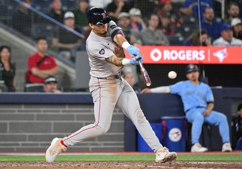 Sep 24, 2024; Toronto, Ontario, CAN;  Boston Red Sox second baseman Vaughn Grissom (5) hits an RBI single against the Toronto Blue Jays in the tenth inning at Rogers Centre. Mandatory Credit: Dan Hamilton-Imagn Images