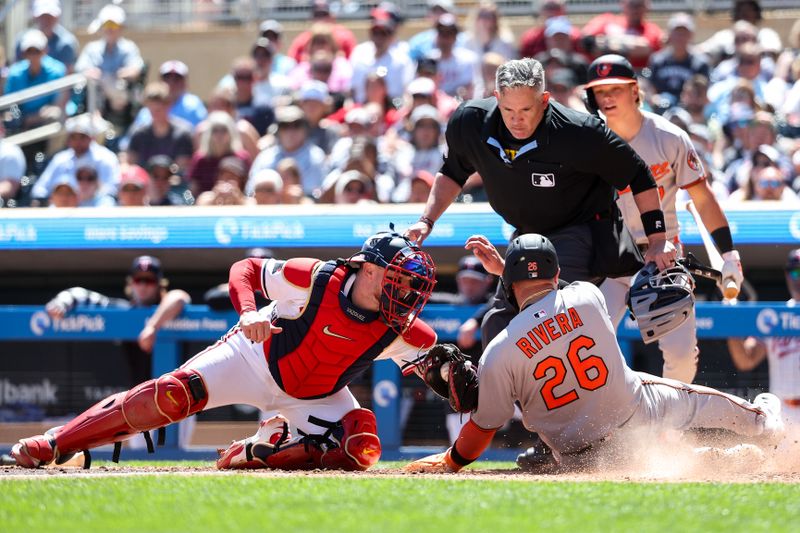 May 8, 2025; Minneapolis, Minnesota, USA; Minnesota Twins catcher Christian Vazquez (8) tags out Baltimore Orioles third baseman Emmanuel Rivera (26) at home plate during the sixth inning at Target Field. Mandatory Credit: Matt Krohn-Imagn Images