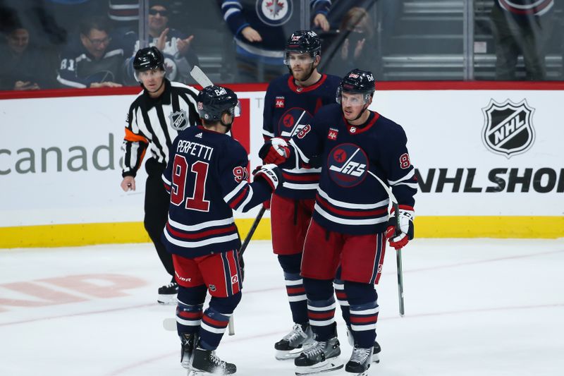 Jan 26, 2023; Winnipeg, Manitoba, CAN;  Winnipeg Jets defenseman Nate Schmidt (88) is congratulated by his team mates on his goal against the Buffalo Sabres during the third period at Canada Life Centre. Mandatory Credit: Terrence Lee-USA TODAY Sports