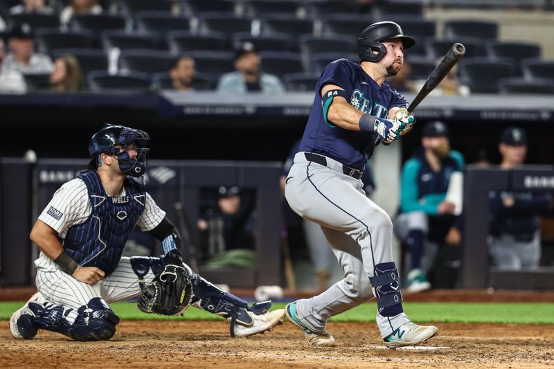 May 22, 2024; Bronx, New York, USA;  Seattle Mariners catcher Cal Raleigh (29) hits a three-run home run in the eighth inning against the New York Yankees at Yankee Stadium. Mandatory Credit: Wendell Cruz-USA TODAY Sports