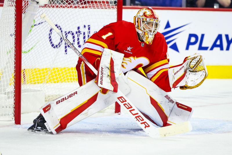 Sep 28, 2024; Calgary, Alberta, CAN; Calgary Flames goaltender Devin Cooley (1) guards his net against the Vancouver Canucks during the third period at Scotiabank Saddledome. Mandatory Credit: Sergei Belski-Imagn Images