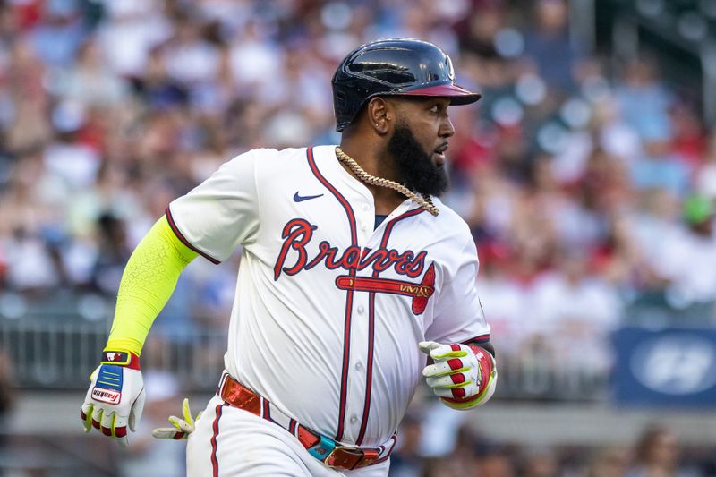 Aug 22, 2024; Cumberland, Georgia, USA; Atlanta Braves designated hitter Marcell Ozuna (20) runs to first base for a single against Philadelphia Phillies during the first inning at Truist Park. Mandatory Credit: Jordan Godfree-USA TODAY Sports