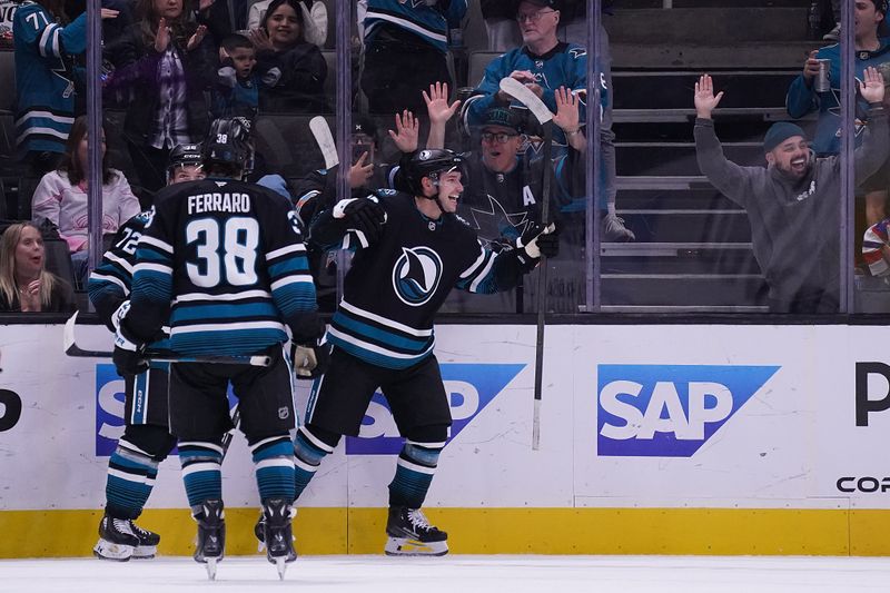 Oct 28, 2025; San Jose, California, USA; San Jose Sharks center Philipp Kurashev (96) celebrates after scoring a goal against the Los Angeles Kings as defenseman Mario Ferraro (38) looks on in the second period at SAP Center at San Jose. Mandatory Credit: David Gonzales-Imagn Images